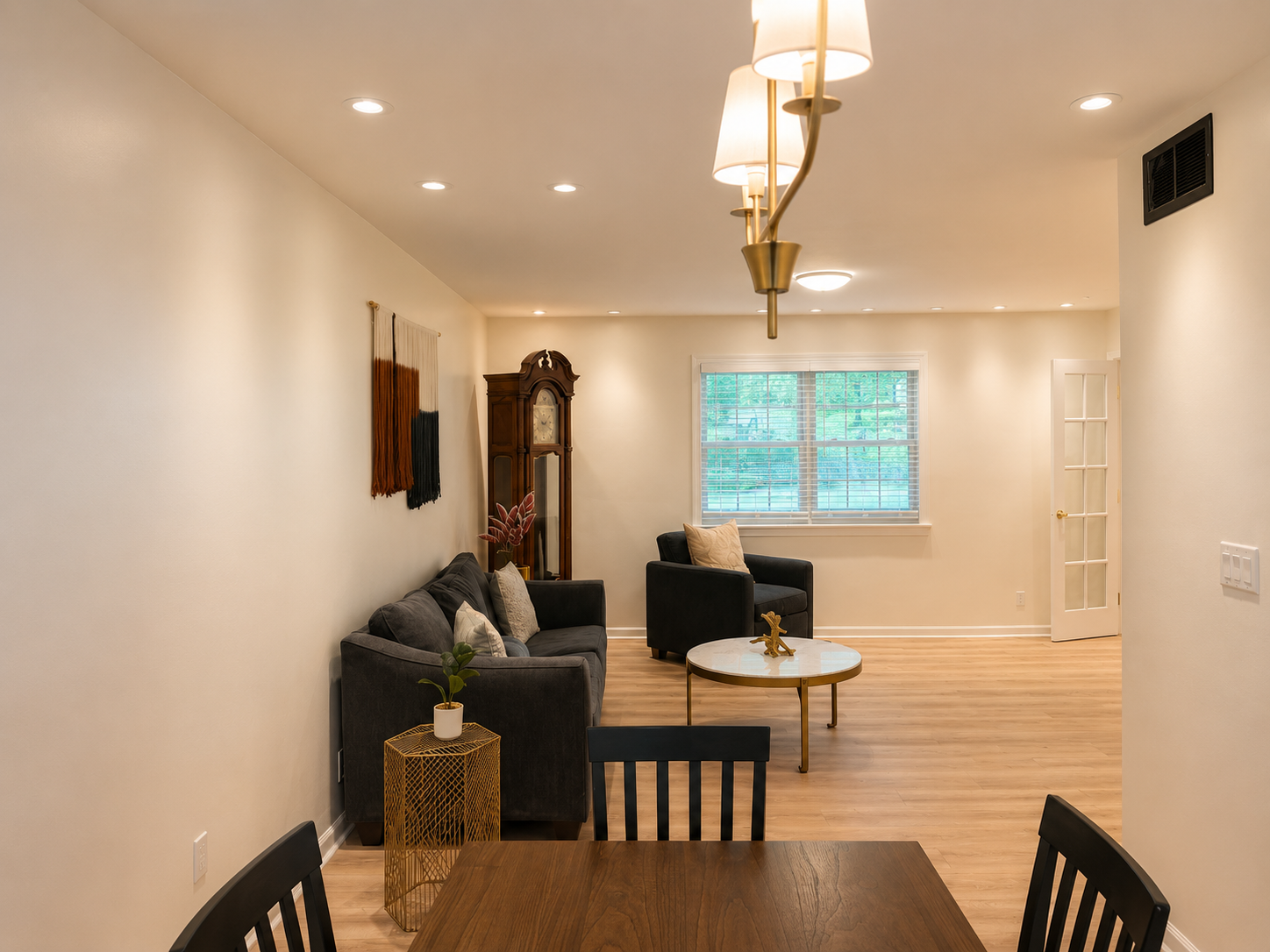 Bright open living & dining space with cozy seating and natural light