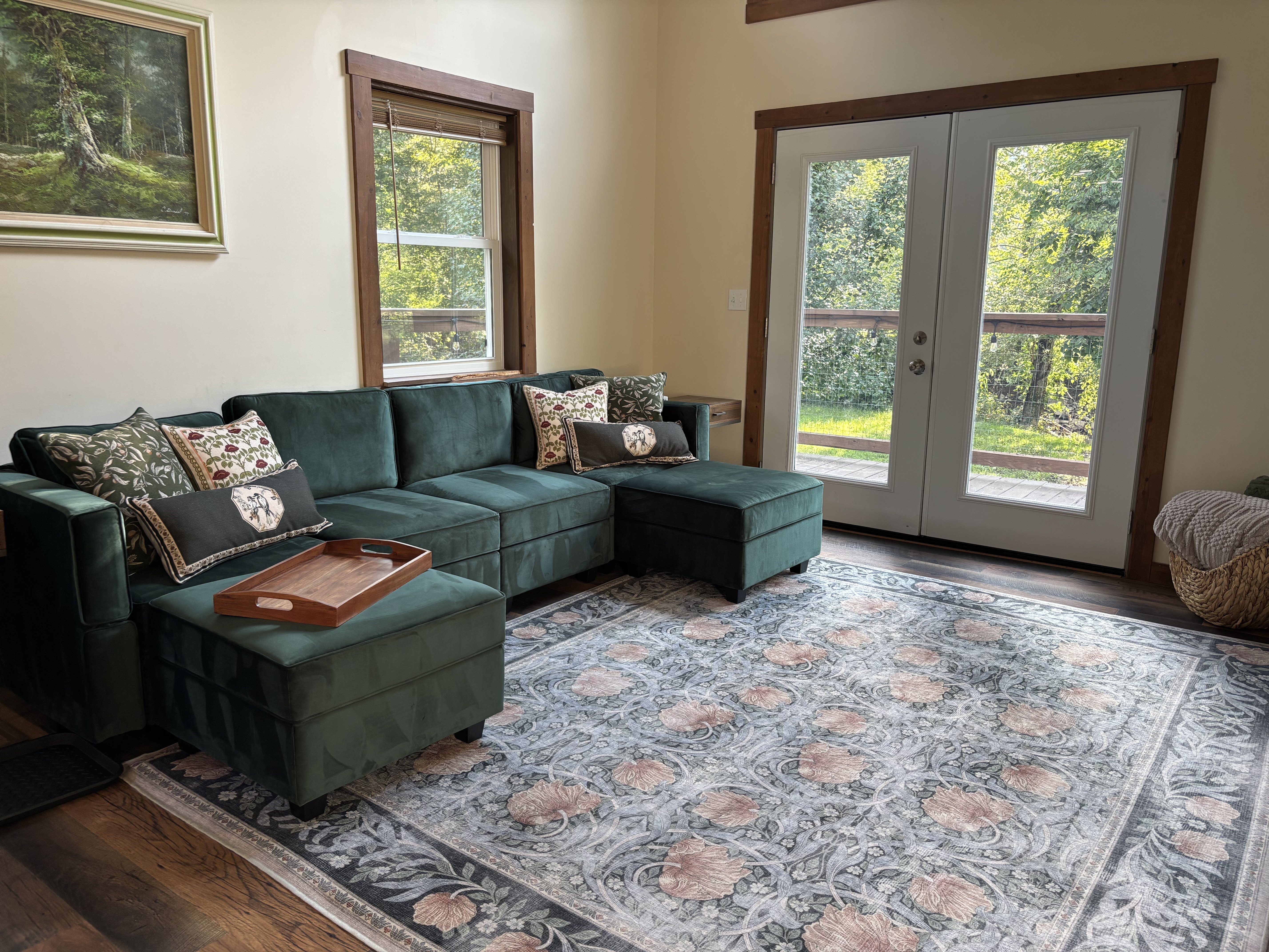 Cozy living room with plush sectional and scenic French door views