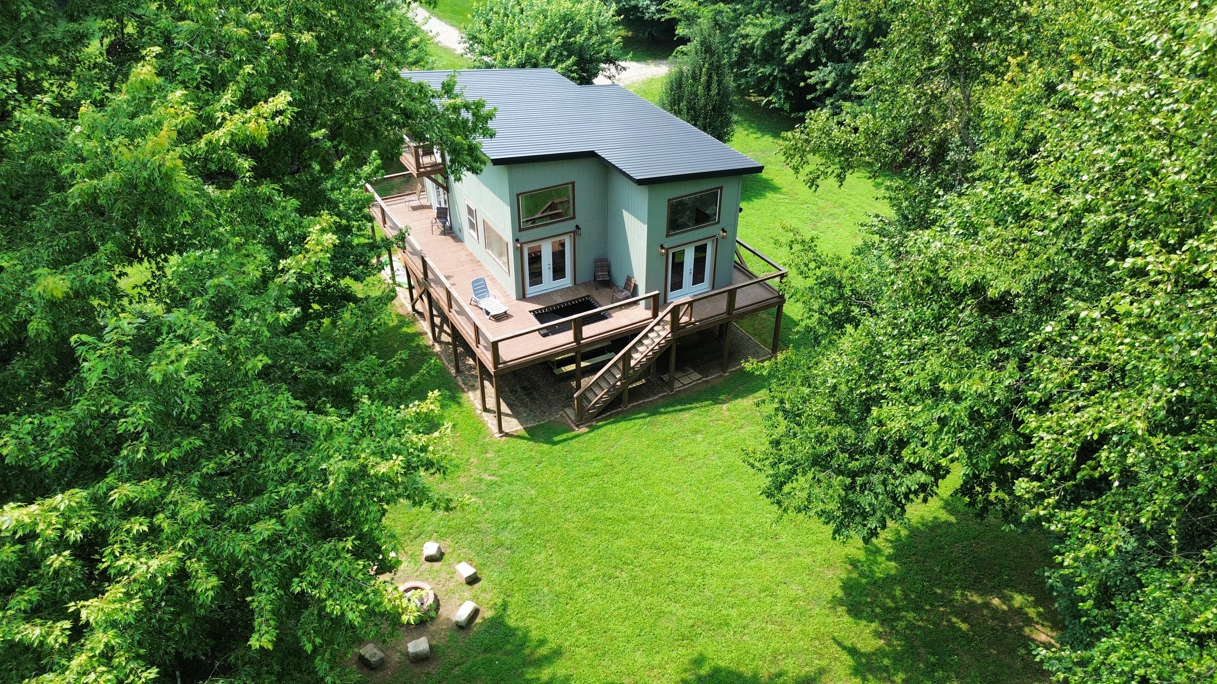 Private woodland retreat with wraparound deck, big yard, and fire pit