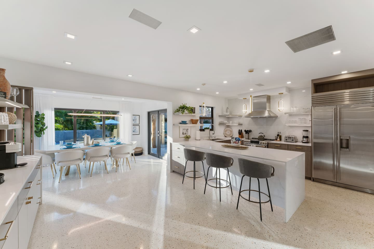 The spacious kitchen makes vacation dining easy with stainless steel appliances, ample seating, and everything needed to prepare and enjoy delicious meals.