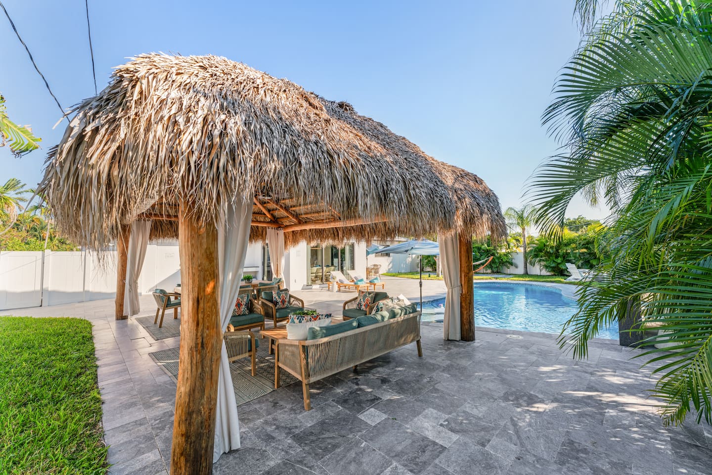 A relaxing cabana space designed for comfort, perfect for enjoying the poolside atmosphere.