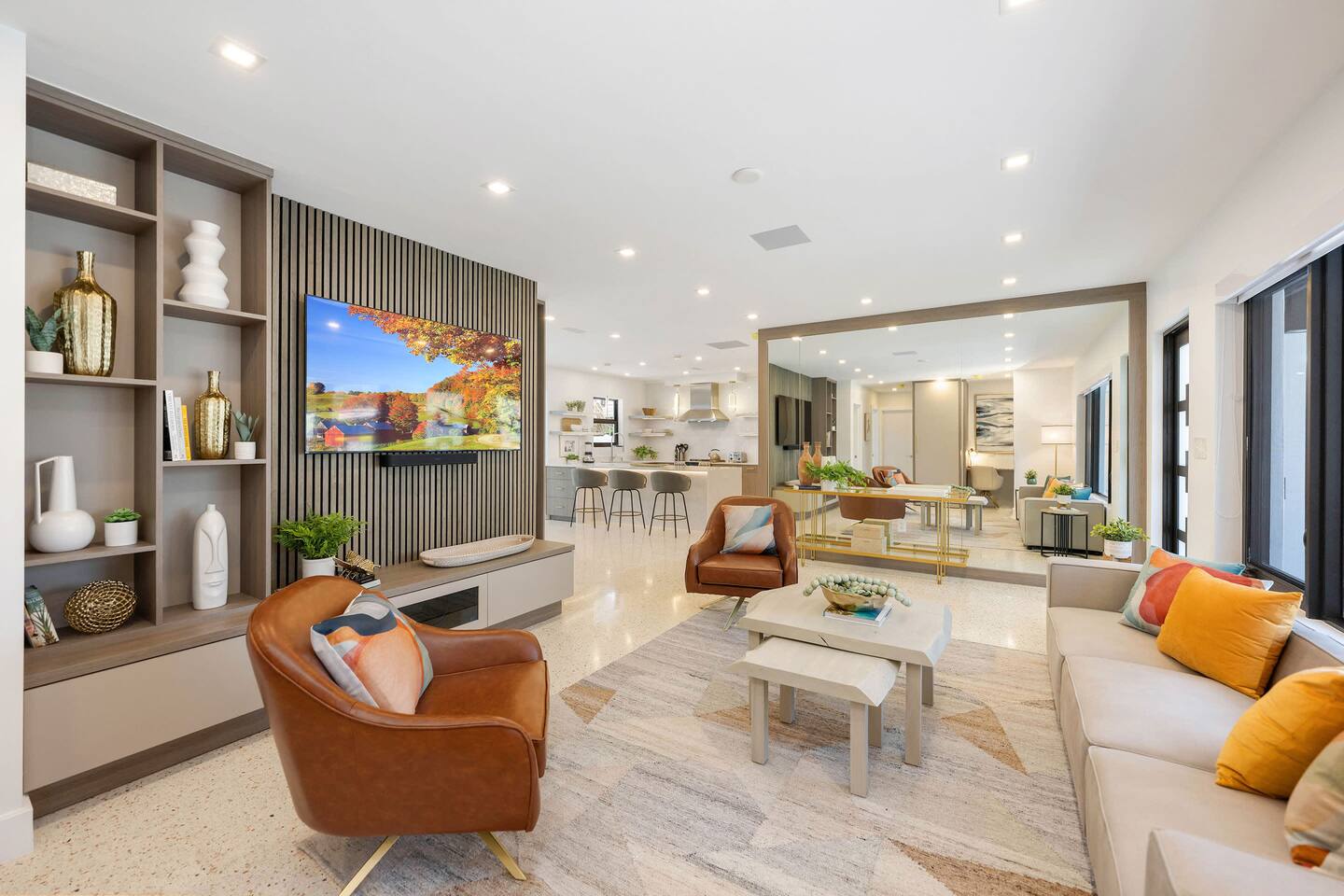 The living room has a comfortable sofa and an 80" Smart TV with Apple TV
