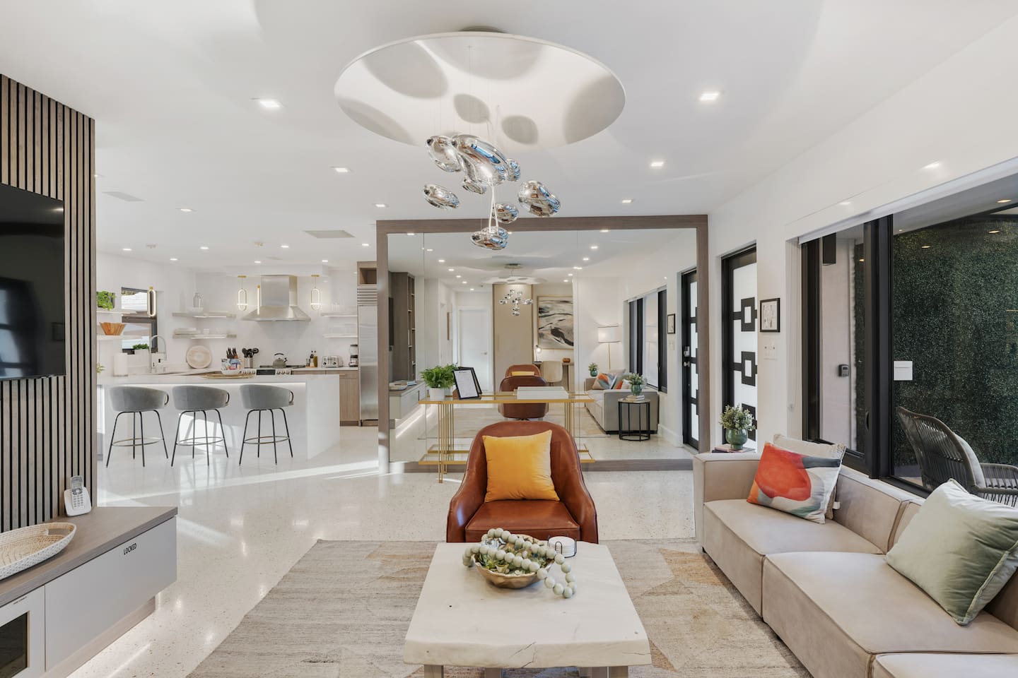 The open floor plan creates an easy flow between the living room, dining area, and fully equipped kitchen.