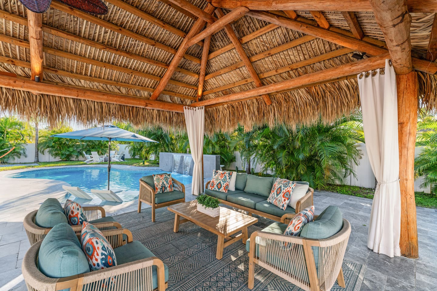 Enjoy a stylish cabana by the pool, providing a shaded space for rest and leisure.