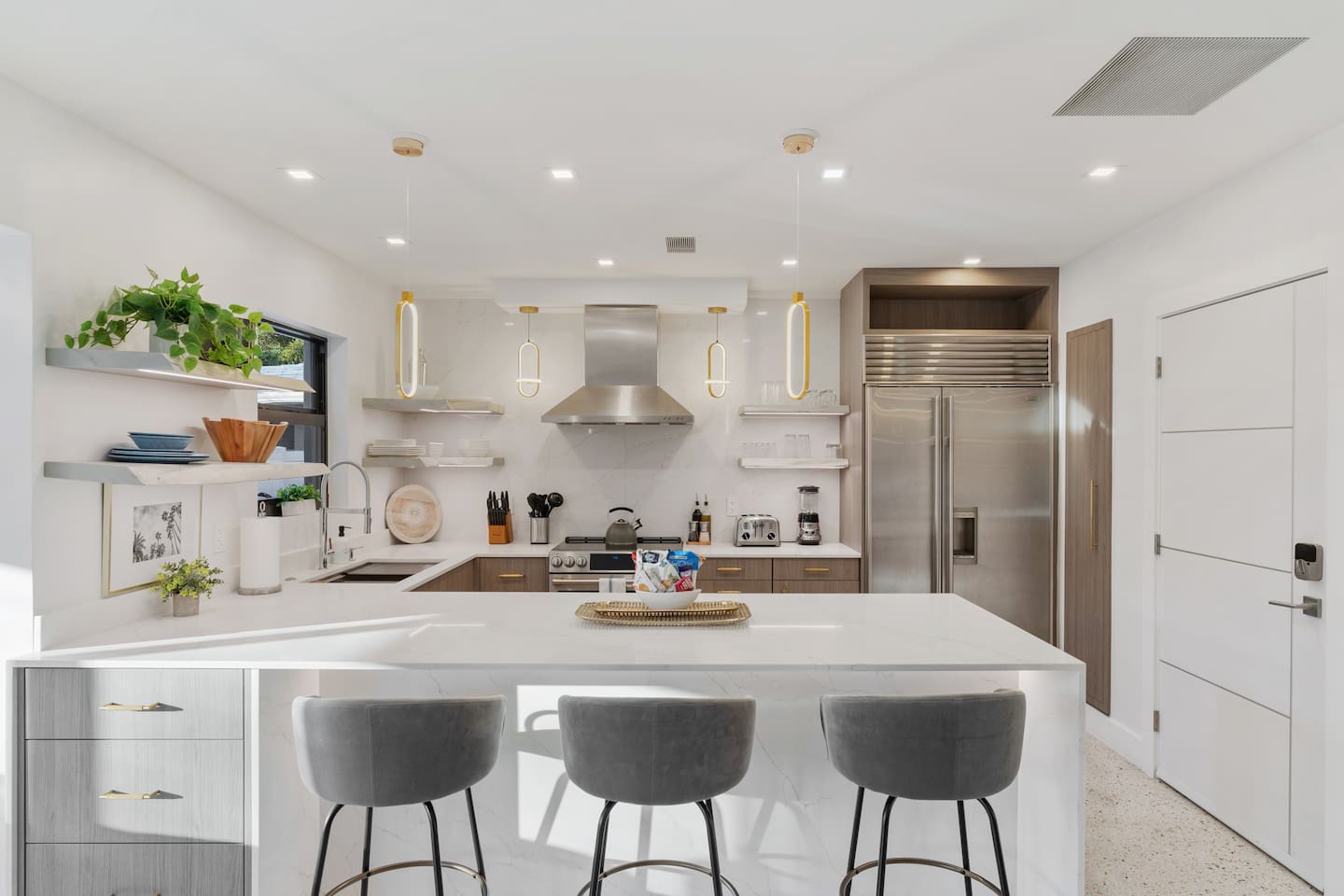 Enjoy a chef-inspired kitchen with plenty of cabinetry, a large fridge, and high-end finishes throughout.