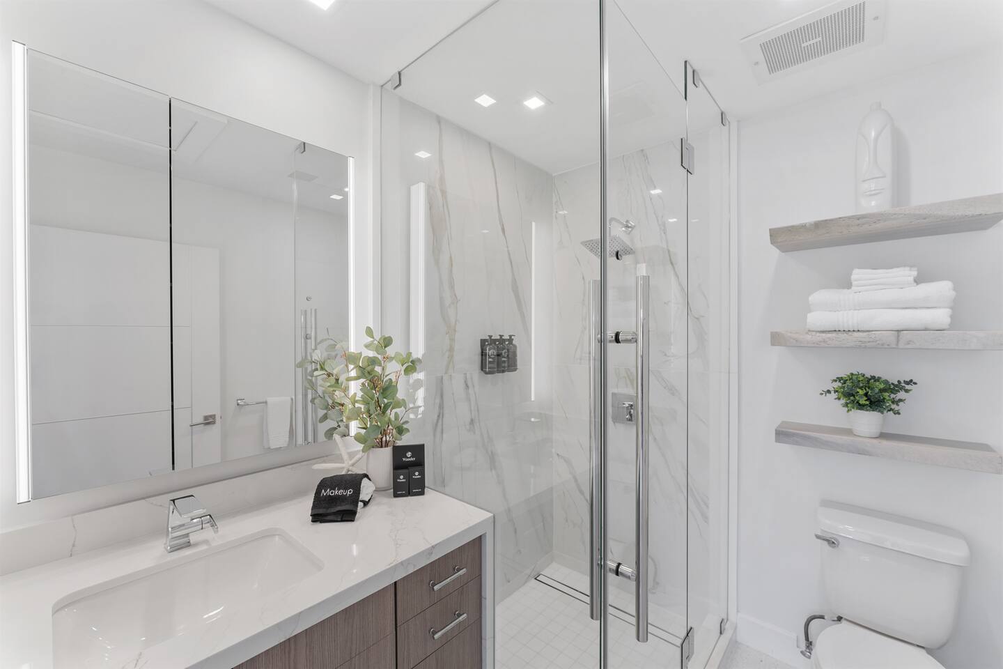 Refresh in the modern ensuite bathroom, complete with a spacious walk-in shower and essential bath amenities.