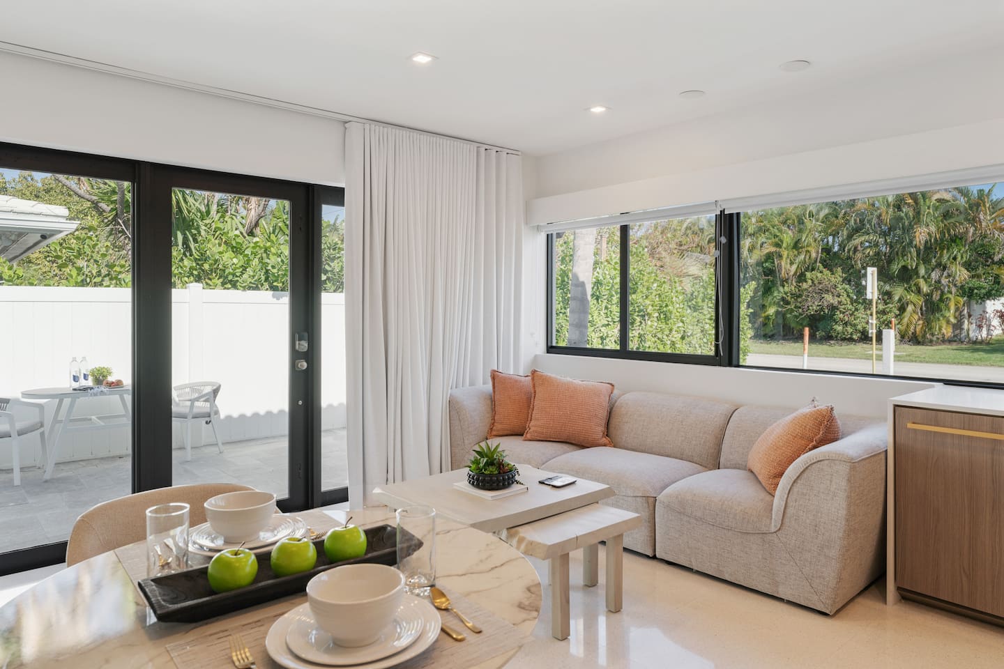 Step through the sliding glass doors to enjoy easy access to the private outdoor space, perfect for relaxing or dining outside.