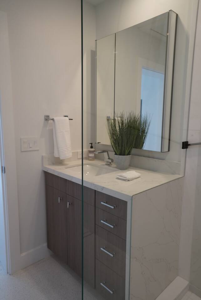 The bathroom has a large vanity mirror