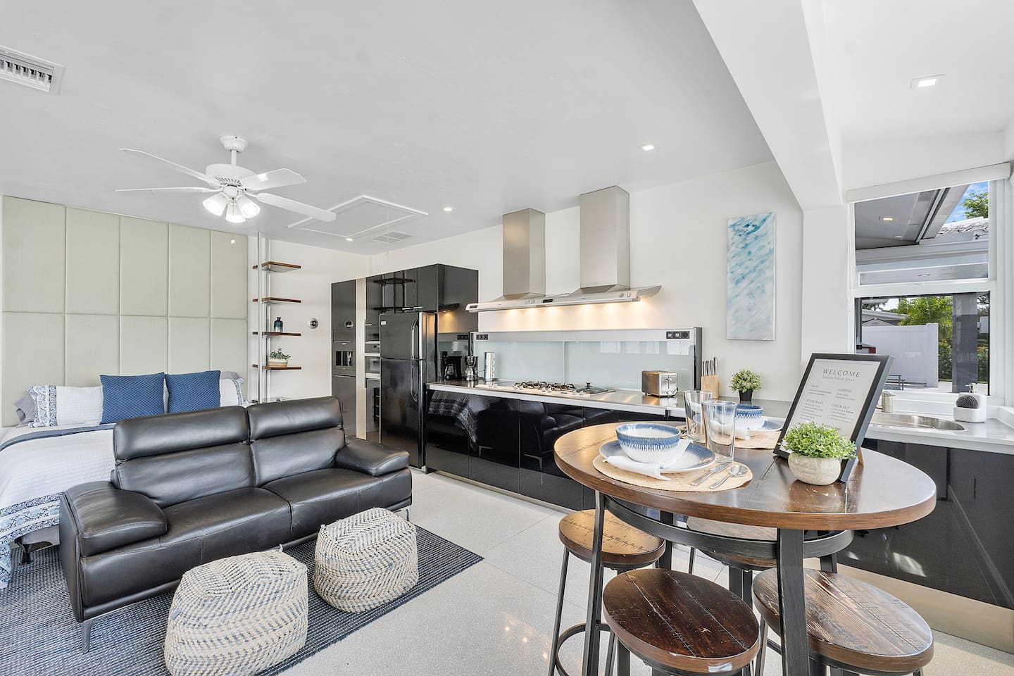 Stretch out in this spacious studio with a king-sized bed, private kitchen, leather accent chairs, generous cabinetry, expansive windows, and a full bathroom with a walk-in shower.