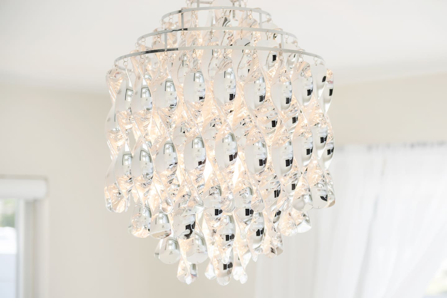 An elegant chandelier adds a touch of sophistication and warmth to the bedroom.