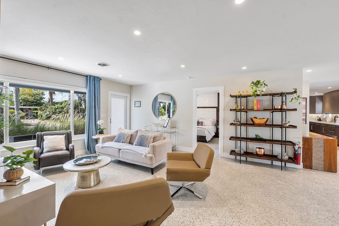 Enjoy a beautifully designed living room with timeless neutral finishes, elegant furnishings, and a large Smart TV.
