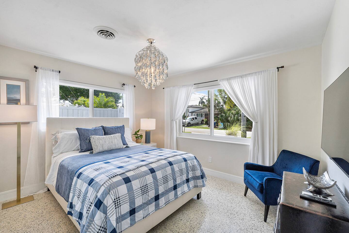 Wake up to abundant natural light streaming through large windows in this beautifully designed bedroom, complete with a queen-size bed and elegant finishes.