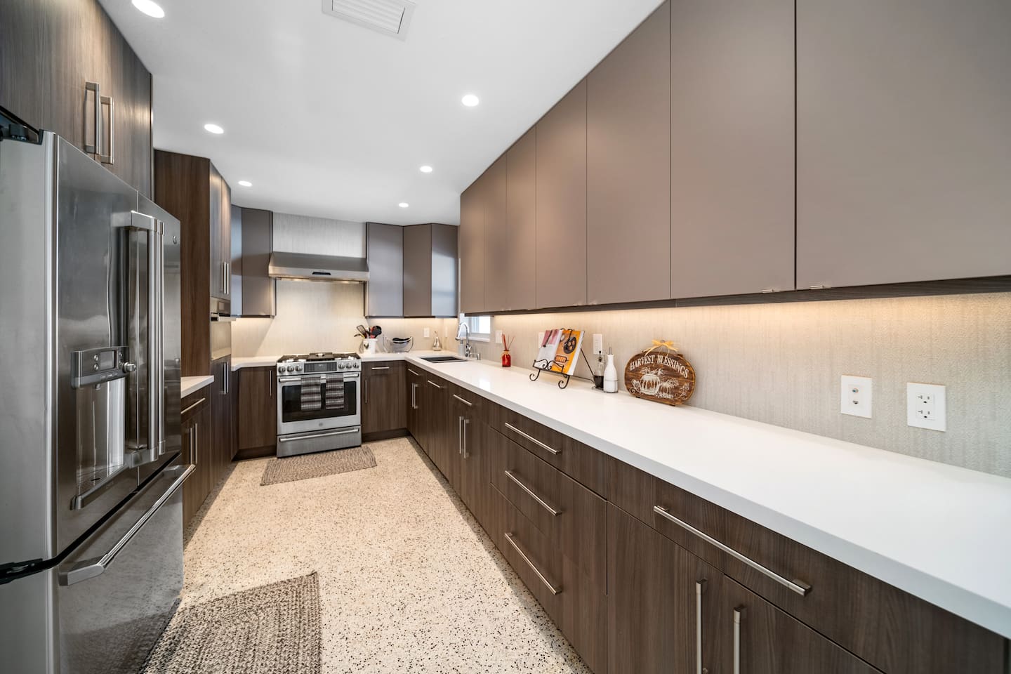 High-end stainless steel appliances and sleek finishes give this kitchen a clean, modern feel while providing everything needed for home-cooked meals.