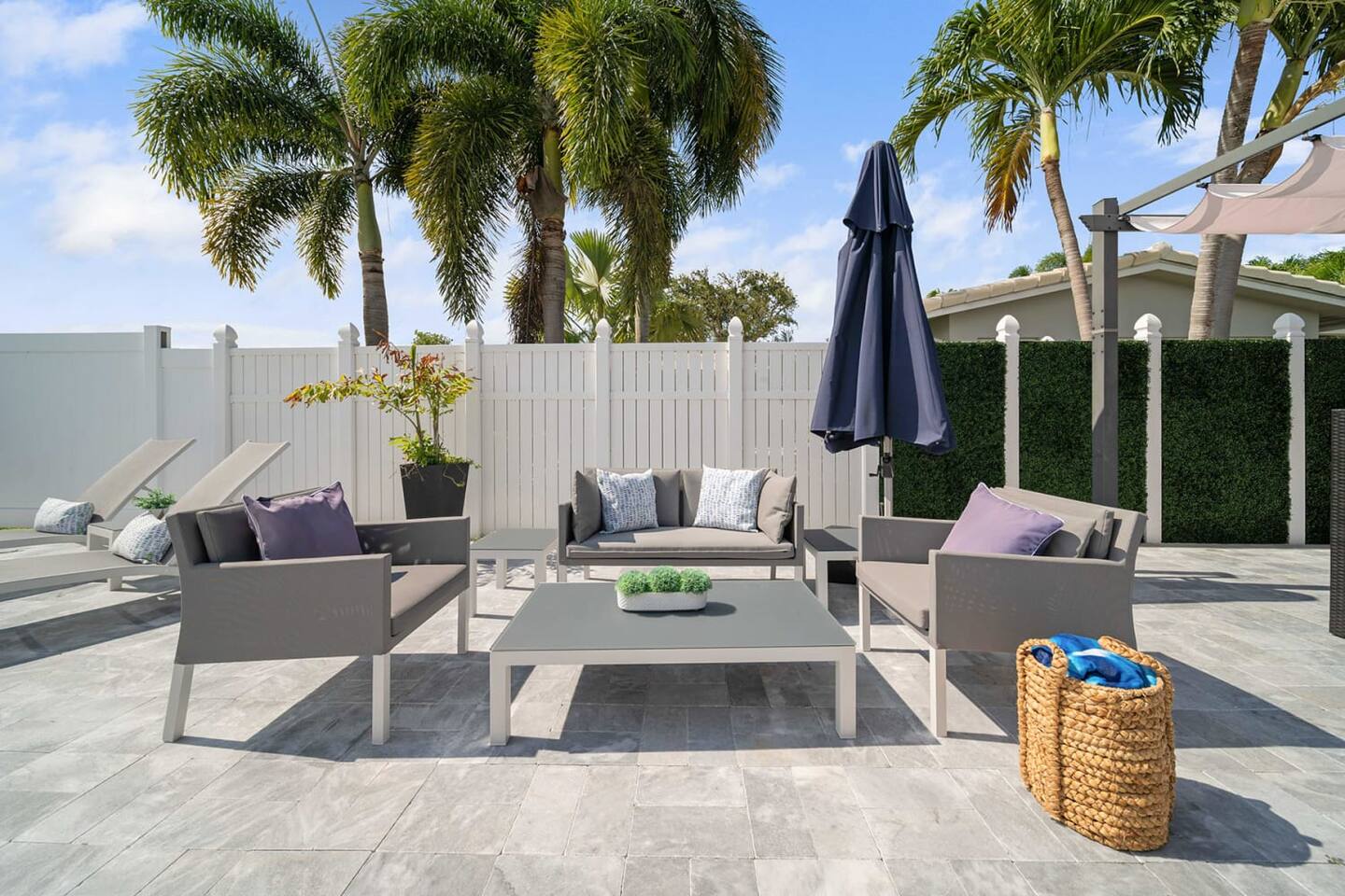 Lounge on the cushy sofa shaded by the umbrella
