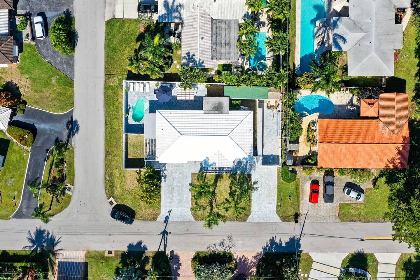 The aerial shot shows the pool and backyard space