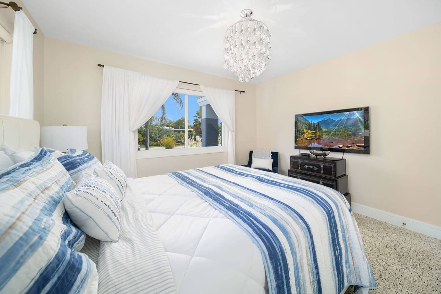 Bedroom 2 is another luminous room & also has a TV