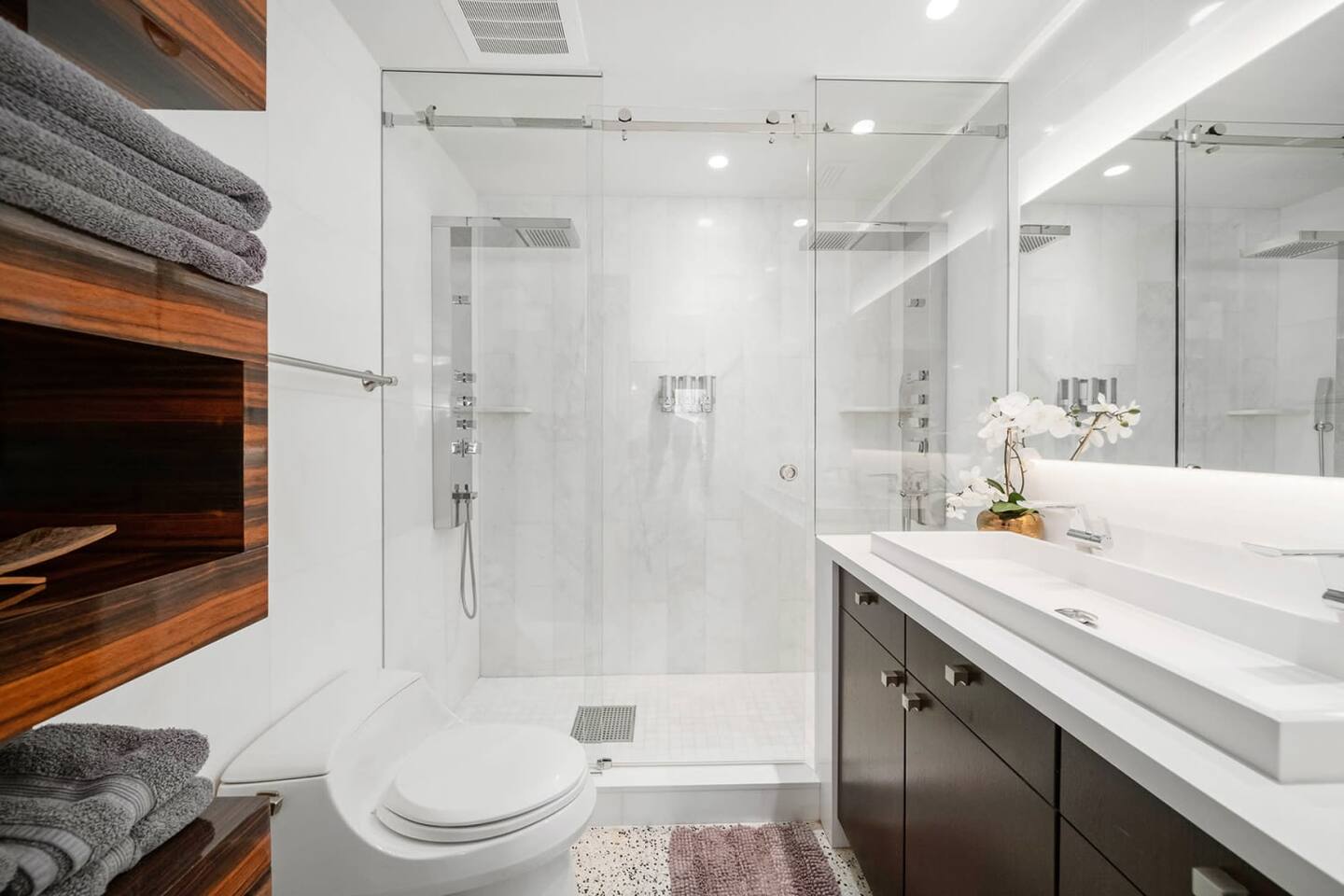 The ensuite bathroom in bedroom w/fantastic shower heads & sleek features