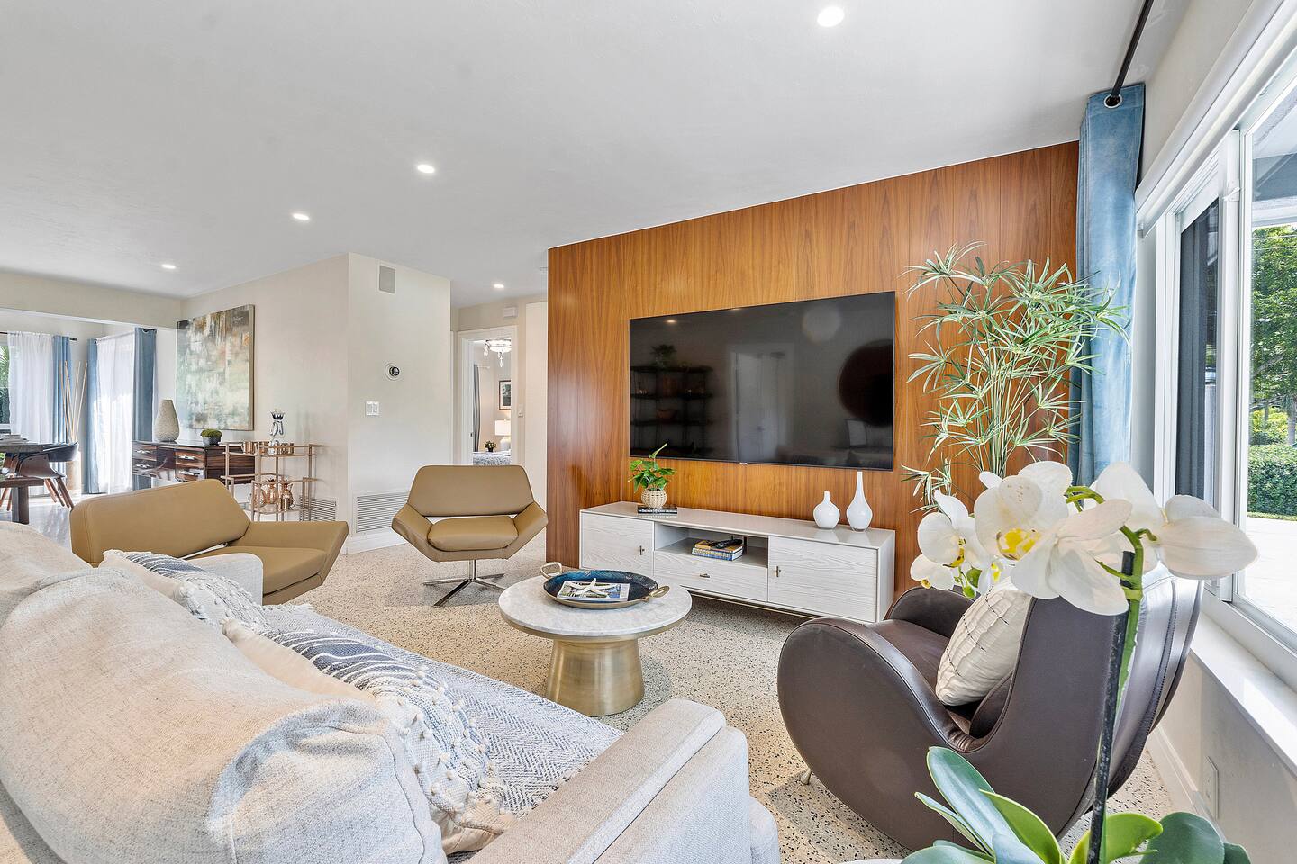 Enjoy the comfortable and varied seating options in the open-concept living and dining area with a large 65" TV
