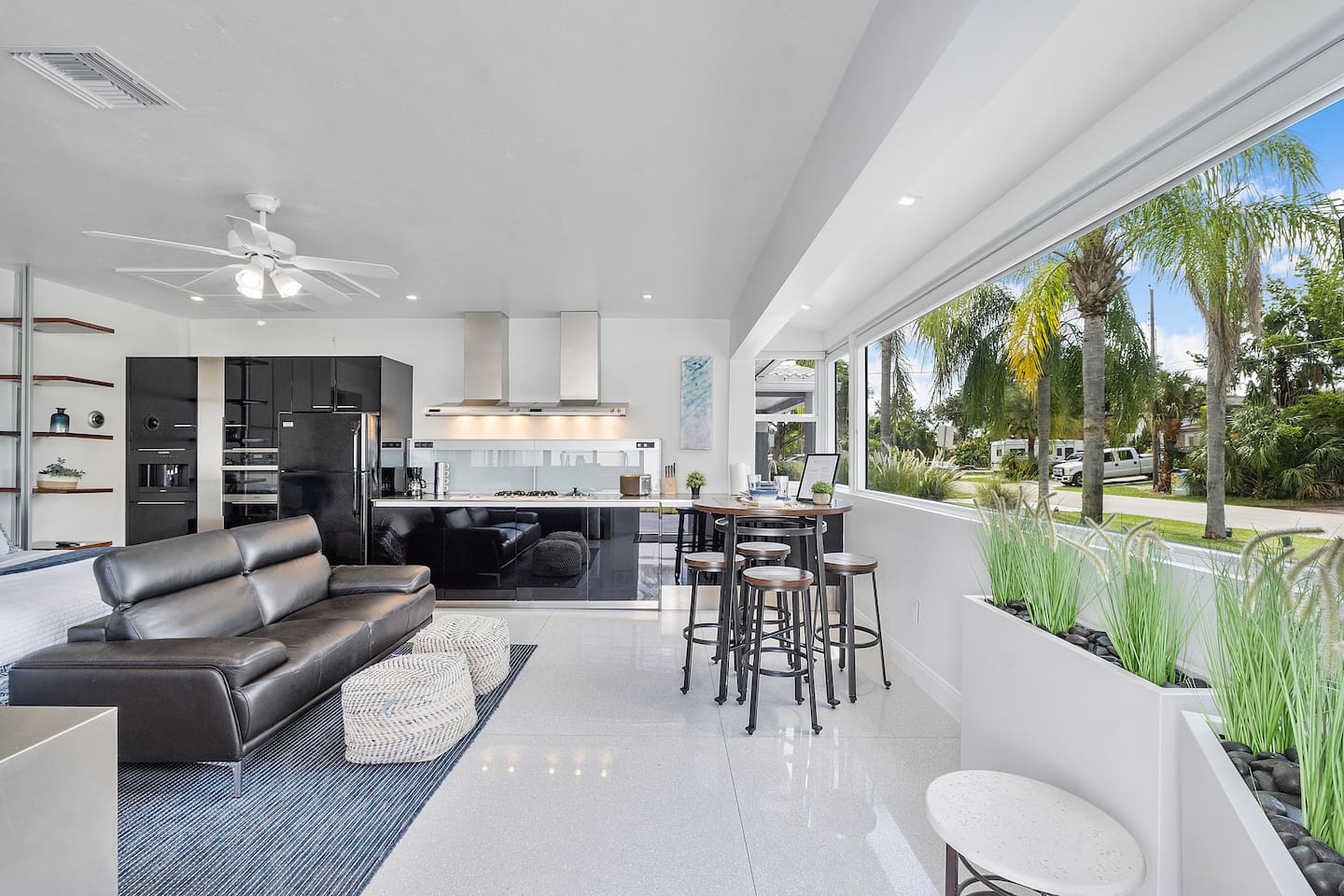 Large glass windows fill the studio with natural light and offer beautiful views of the outdoor space, creating a bright and welcoming atmosphere.