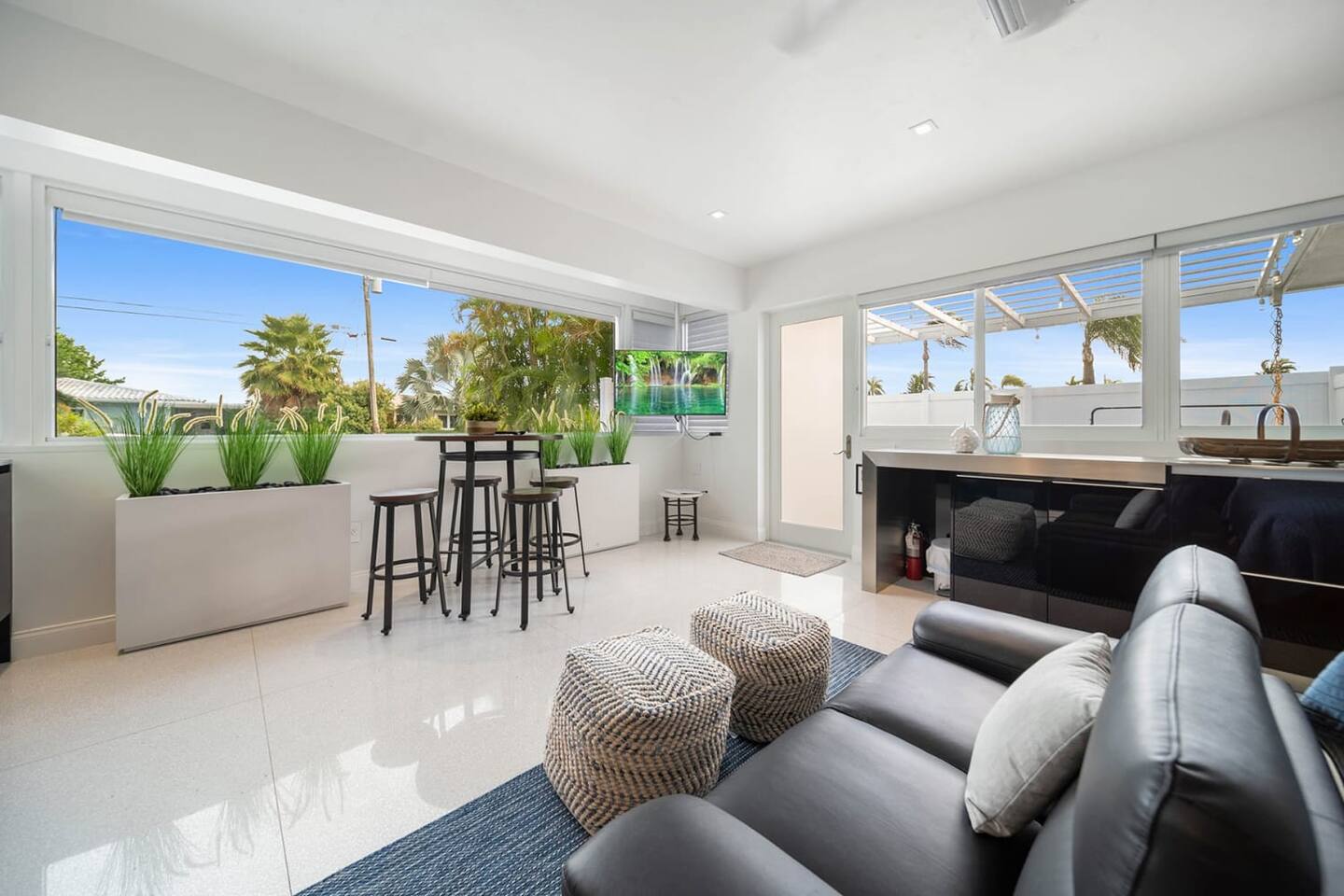 A plush sofa and sun-drenched dining area