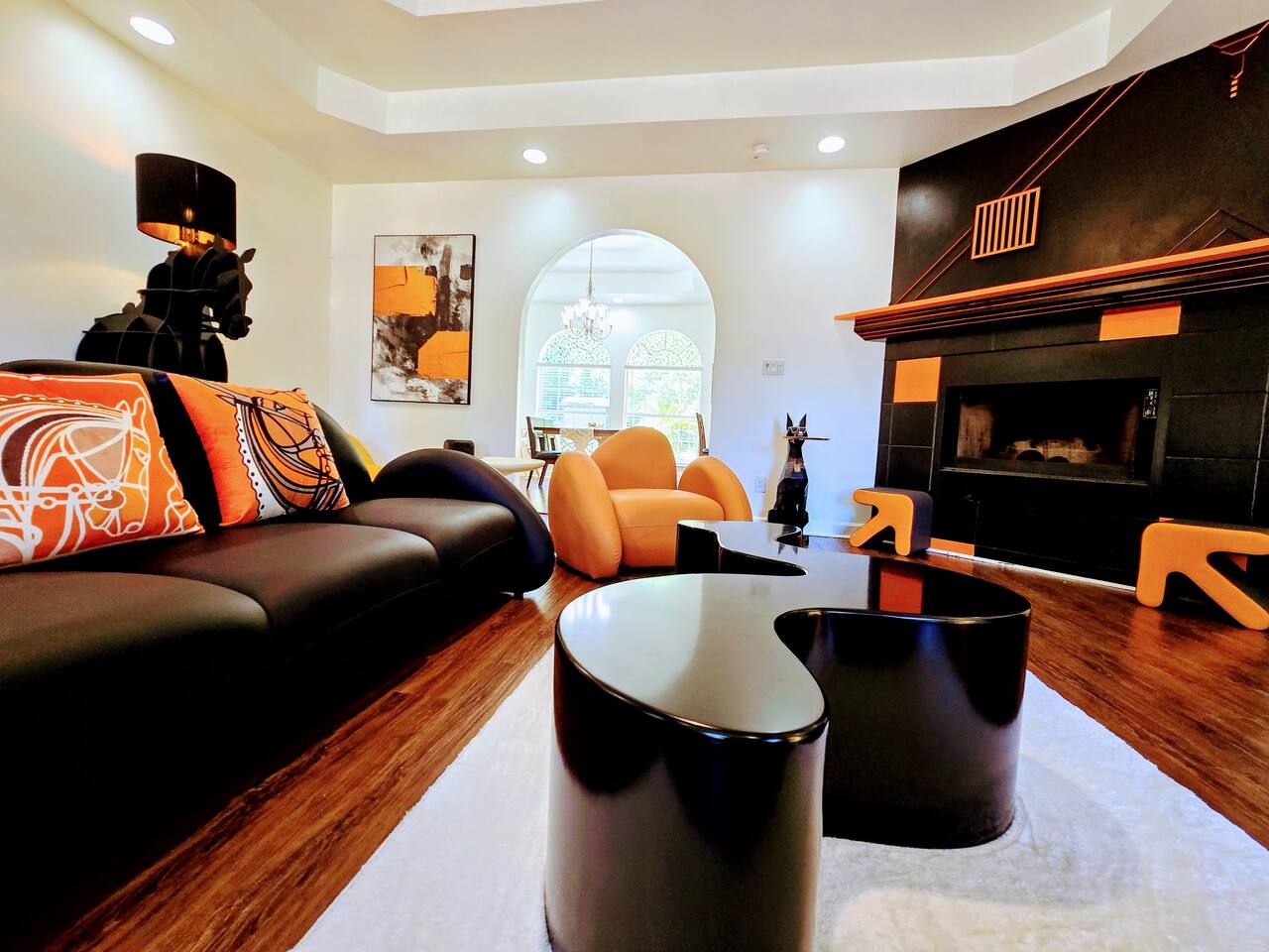 The large living room is well adorned with unique furniture sourced from around the globe. Every item has been carefully chosen for their quality, comfort, and design characteristics.
