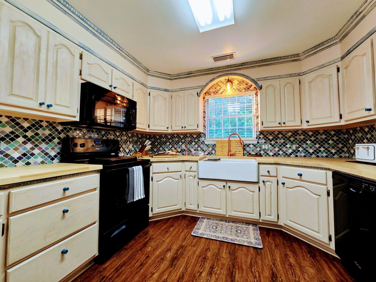 Relish in the custom everything in this delightful, fully loaded, kitchen! From the butcher block counter tops to cabinet trim and HUGE farmhouse sink, every apsect of this kitchen has been crafted for your cooking and gathering experience.