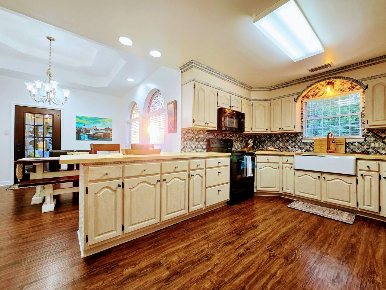 Relish in the custom everything in this delightful, fully loaded, kitchen! From the butcher block counter tops to cabinet trim and HUGE farmhouse sink, every apsect of this kitchen has been crafted for your cooking and gathering experience.