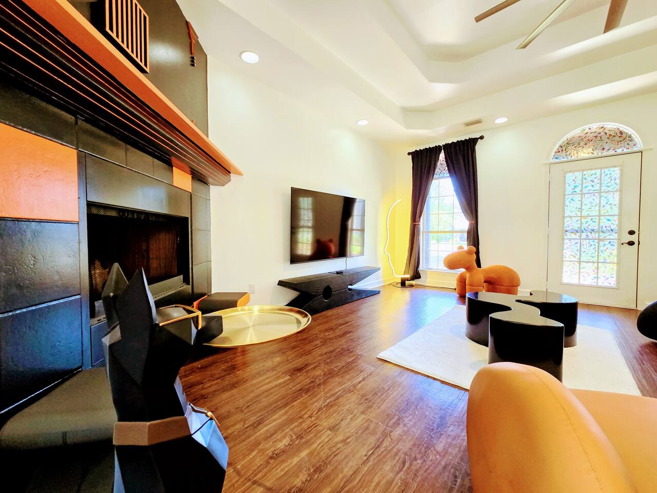 The large living room is well adorned with unique furniture sourced from around the globe. Every item has been carefully chosen for their quality, comfort, and design characteristics.