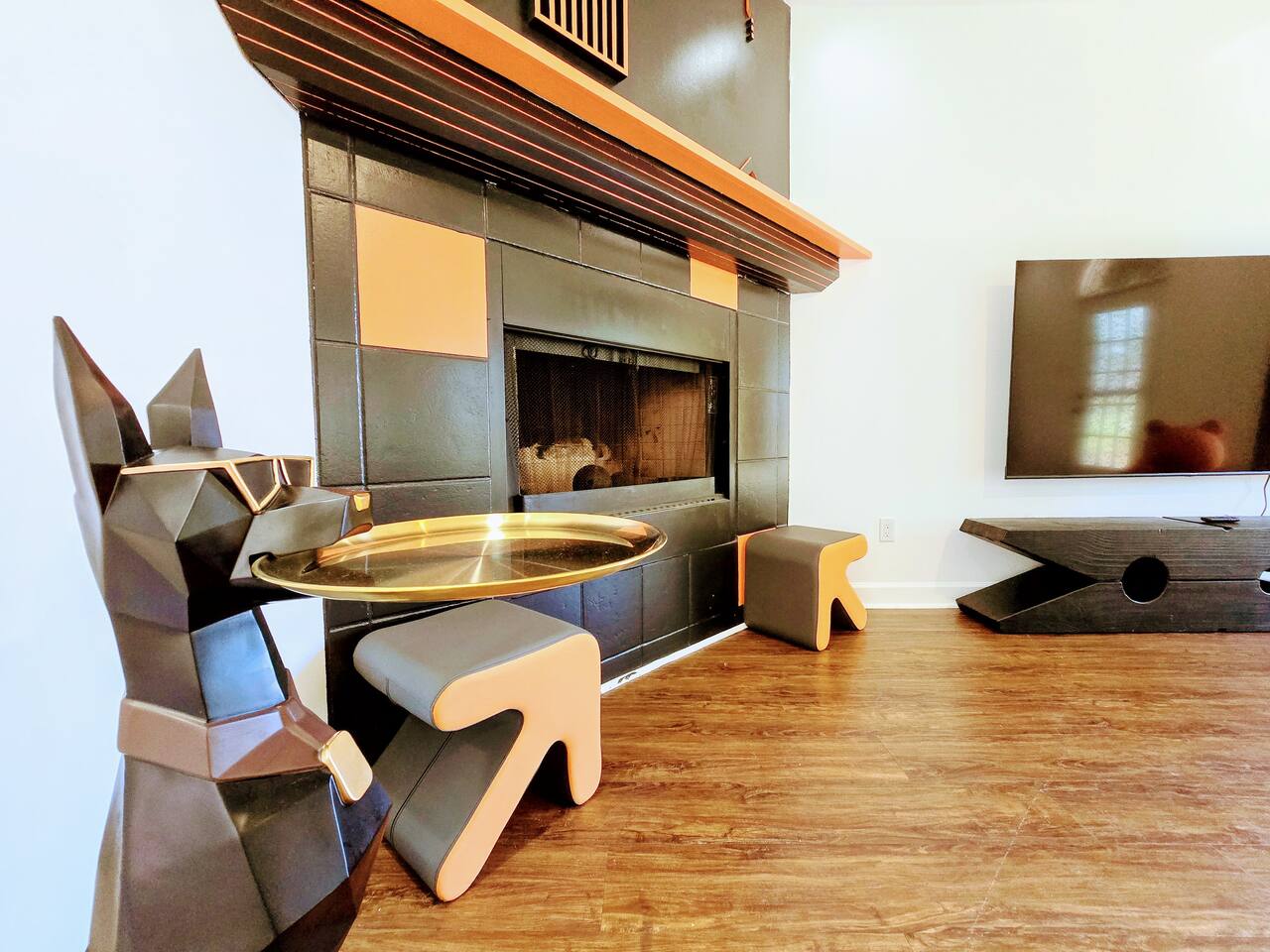 The large living room is well adorned with unique furniture sourced from around the globe. Every item has been carefully chosen for their quality, comfort, and design characteristics.