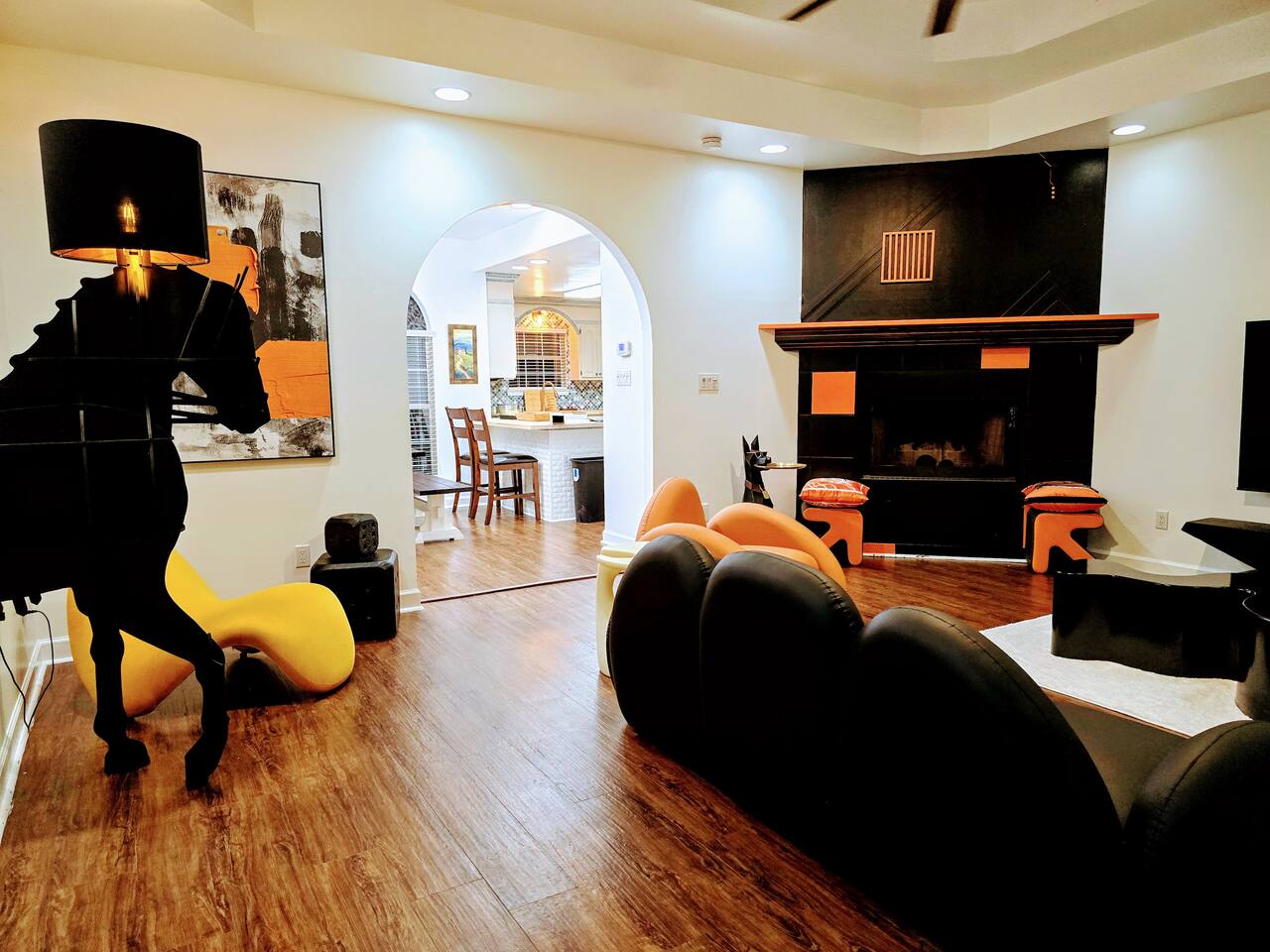 The large living room is well adorned with unique furniture sourced from around the globe. Every item has been carefully chosen for their quality, comfort, and design characteristics.