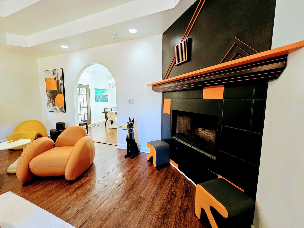 The large living room is well adorned with unique furniture sourced from around the globe. Every item has been carefully chosen for their quality, comfort, and design characteristics.
