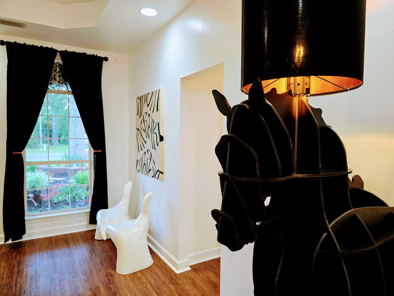 The large living room is well adorned with unique furniture sourced from around the globe. Every item has been carefully chosen for their quality, comfort, and design characteristics.