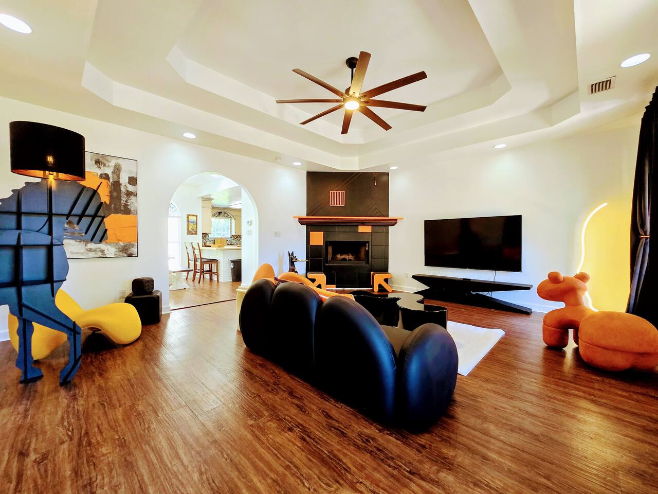 The large living room is well adorned with unique furniture sourced from around the globe. Every item has been carefully chosen for their quality, comfort, and design characteristics.