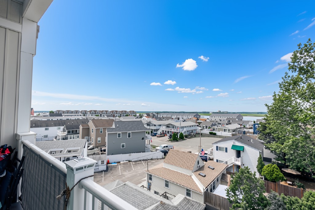 Private balcony with neighborhood views and a peek of the water