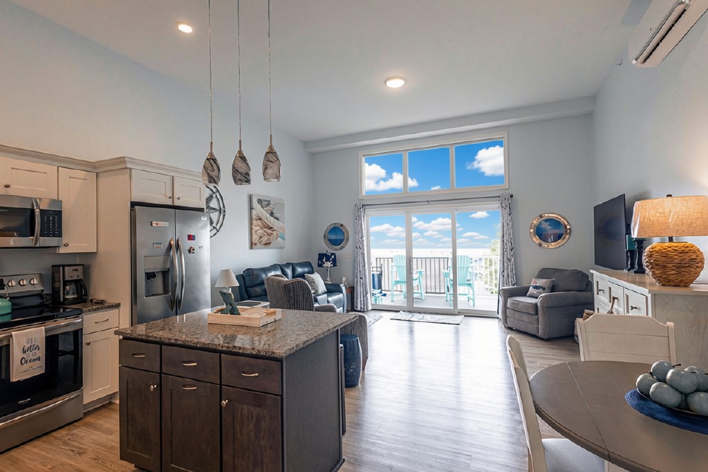 Bright open living area with balcony seating and beautiful water views