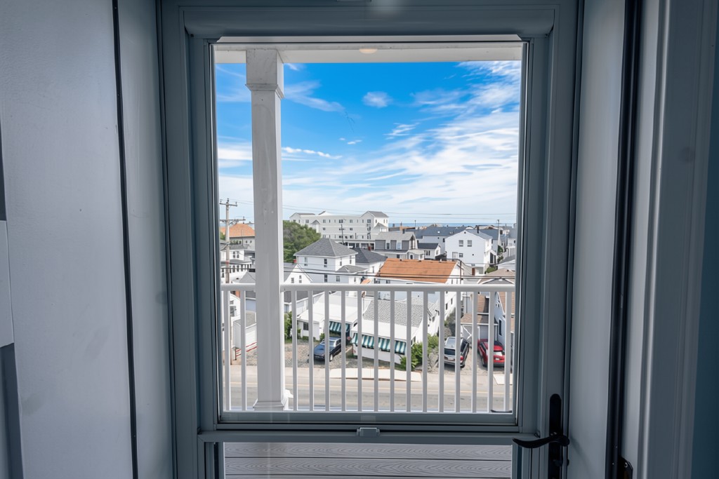 Private balcony with bright neighborhood views and a peek of the water