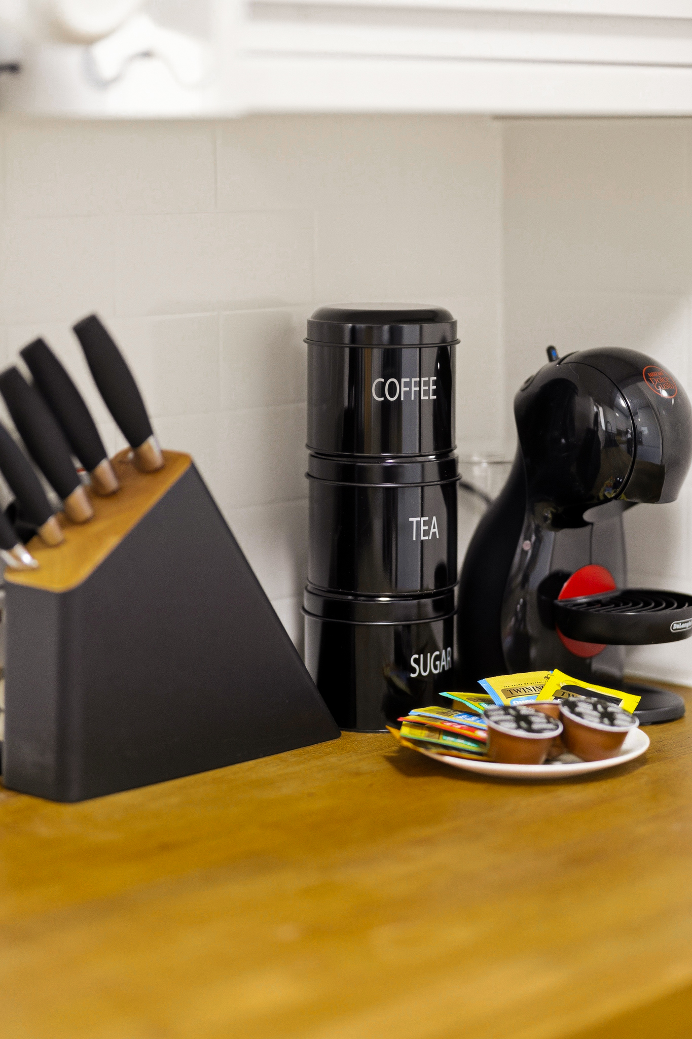 Well-stocked kitchen coffee station with modern countertop essentials