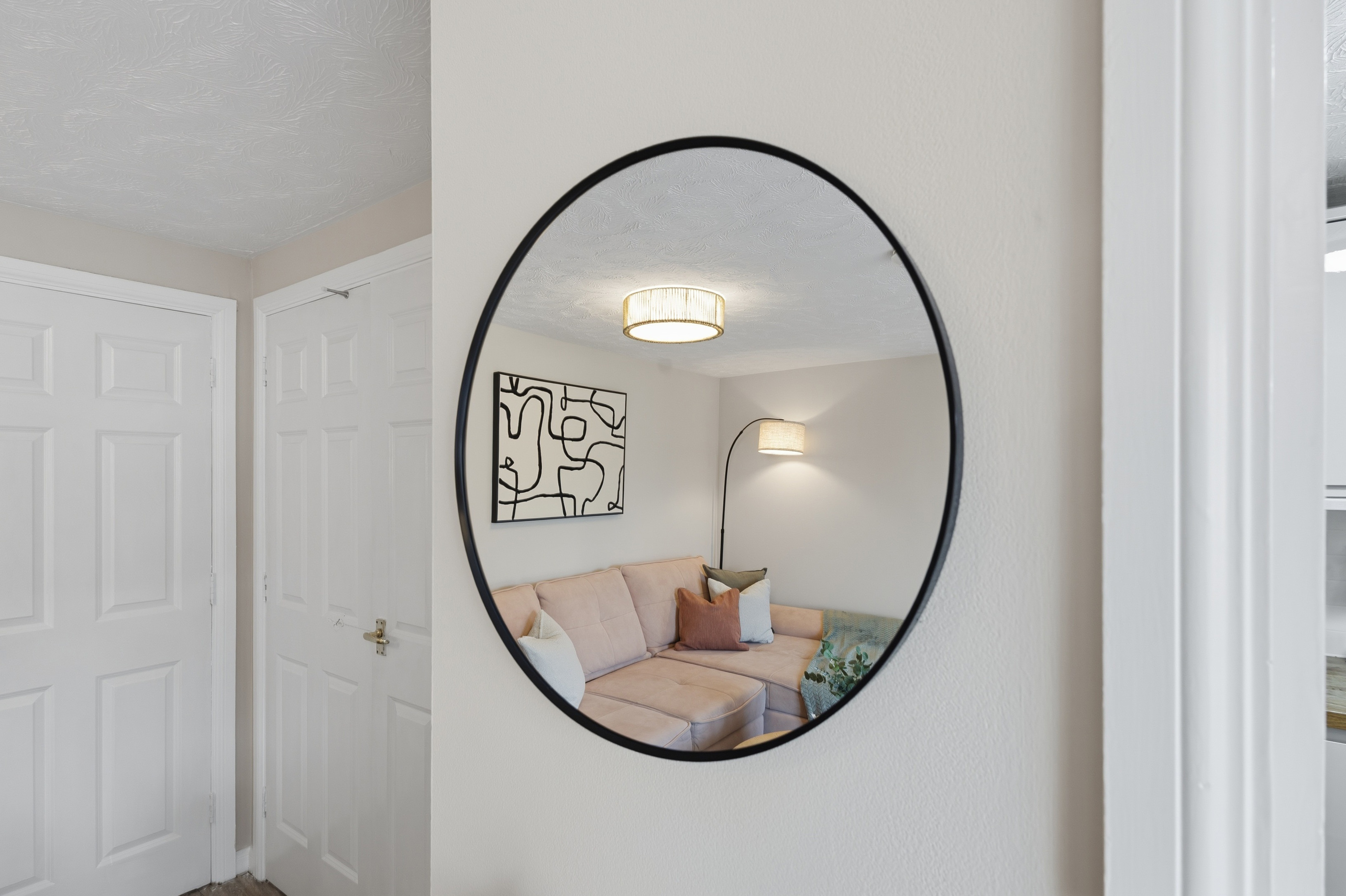 Stylish mirror view into a bright, cozy living space