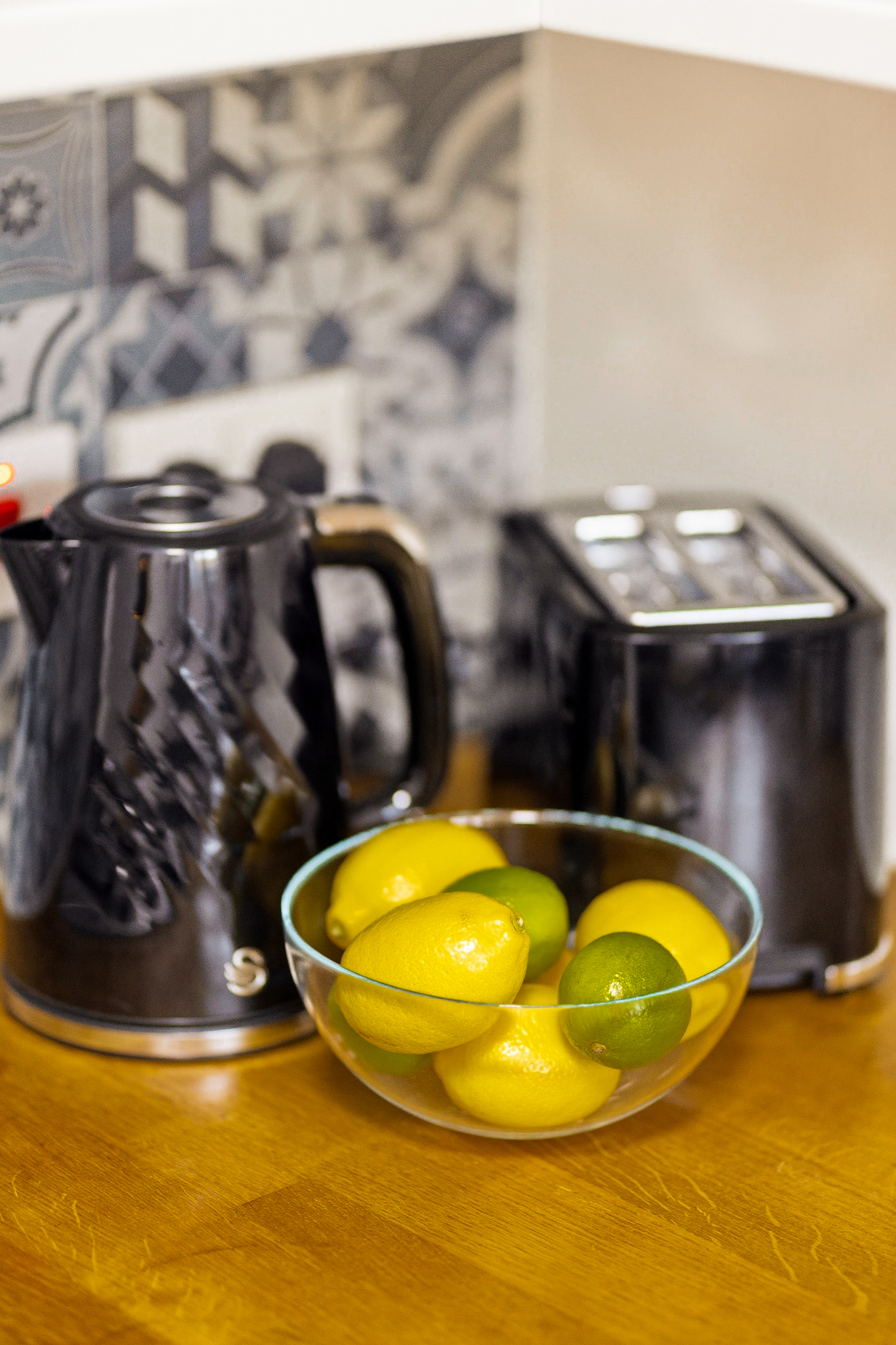Stylish kitchen setup with kettle, toaster, and fresh citrus accents