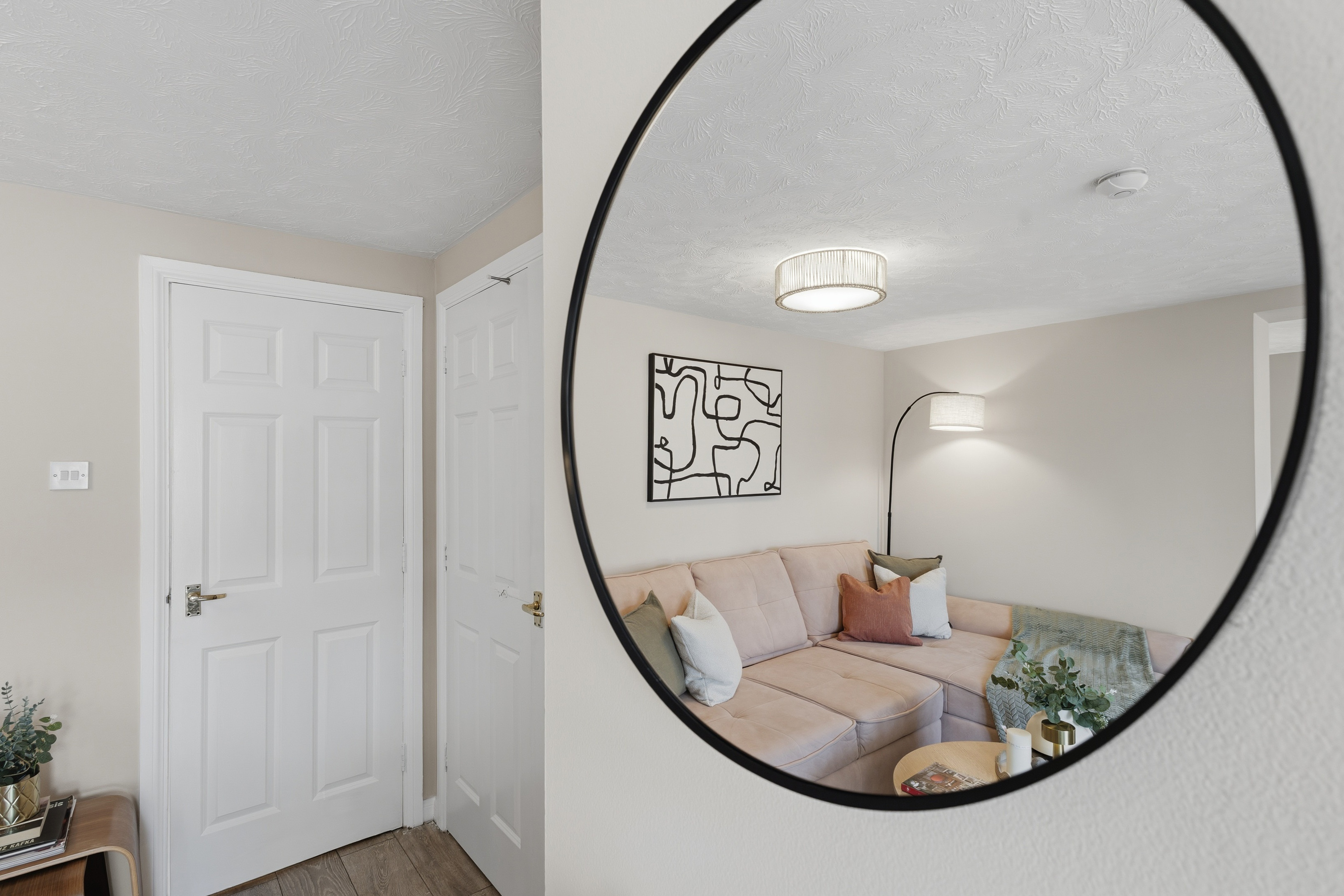 Stylish mirror entry with a cozy, modern lounge just beyond