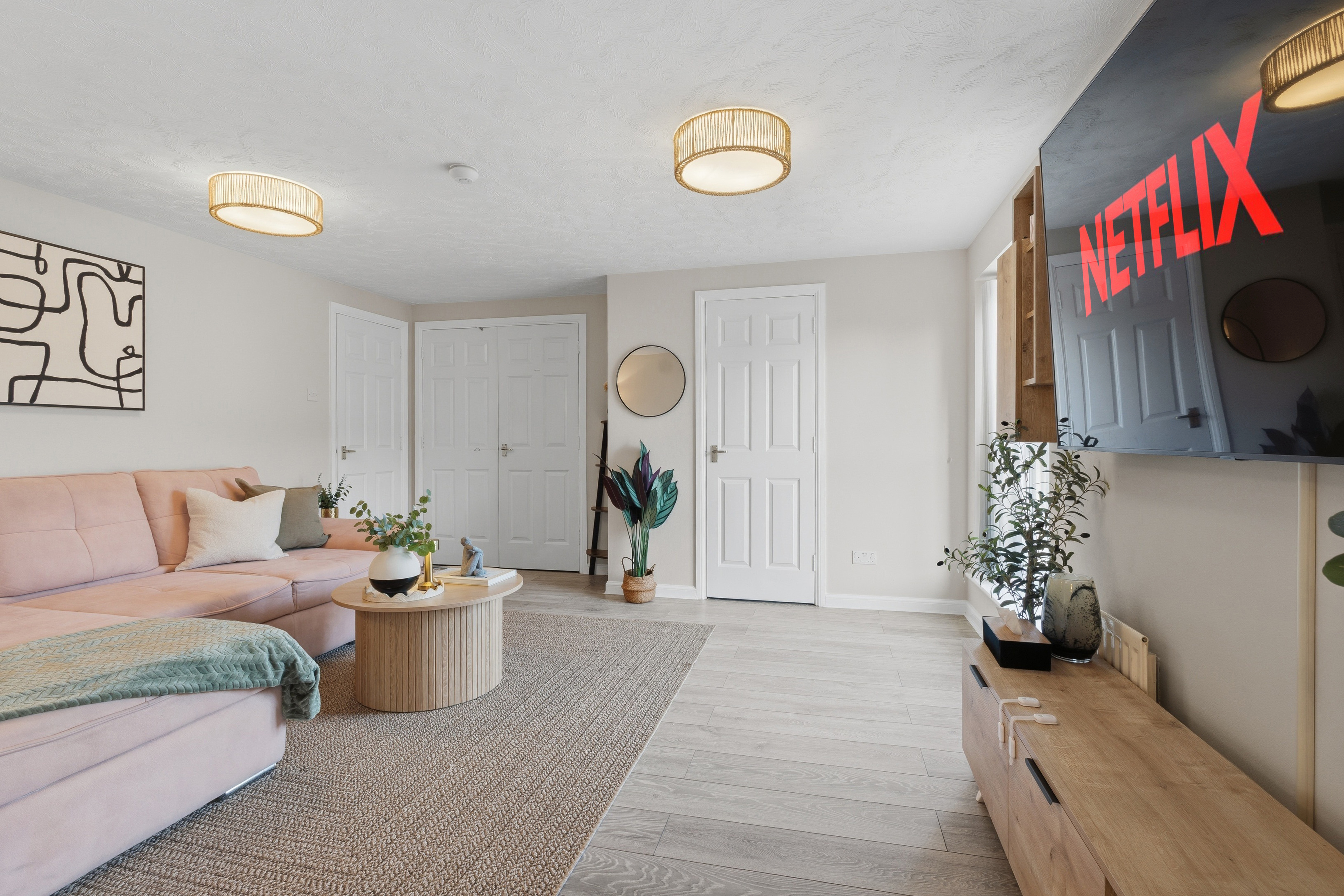 Bright modern lounge with plush sectional and Netflix-ready TV