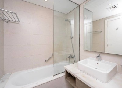 Modern bathroom with bathtub and overhead shower