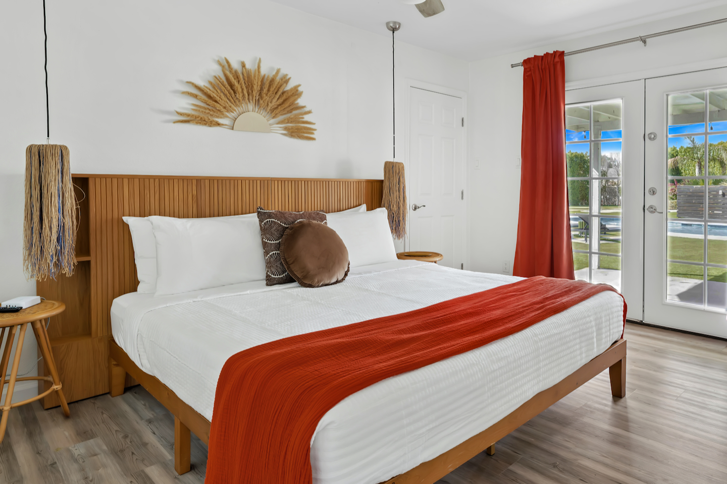 Bright boho bedroom with king bed and French doors to the outdoors