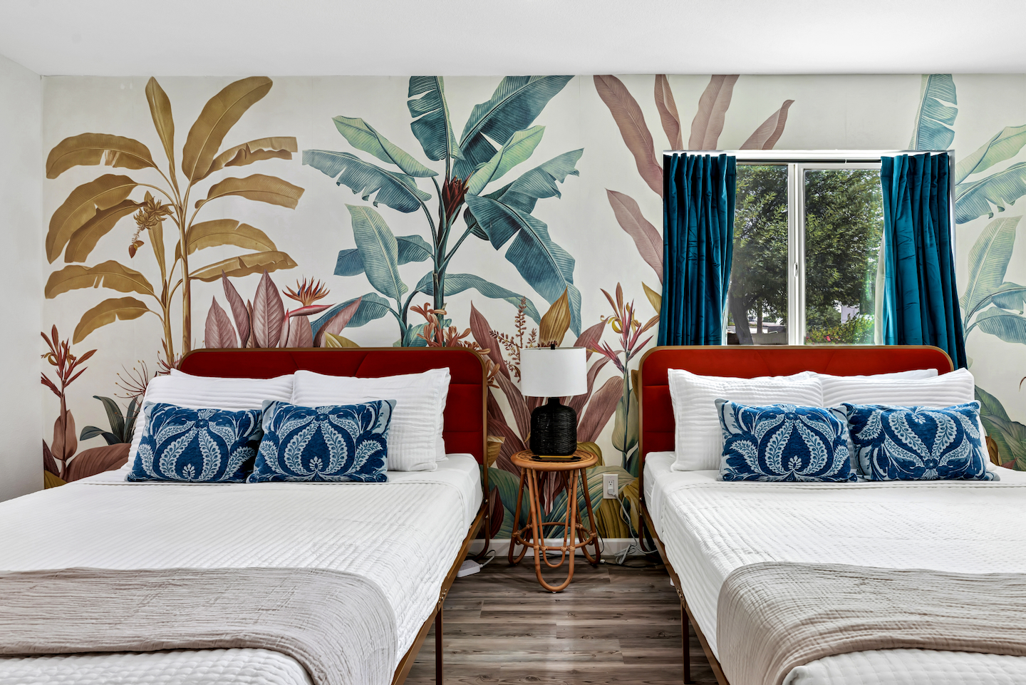 Stylish double bedroom with tropical mural and vibrant designer touches