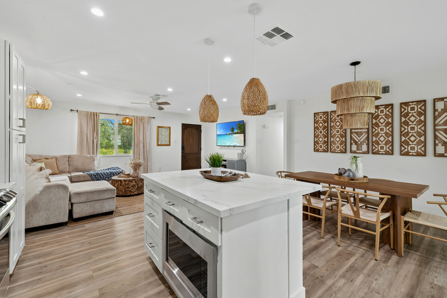 Bright open-concept living with designer kitchen island and cozy dining area