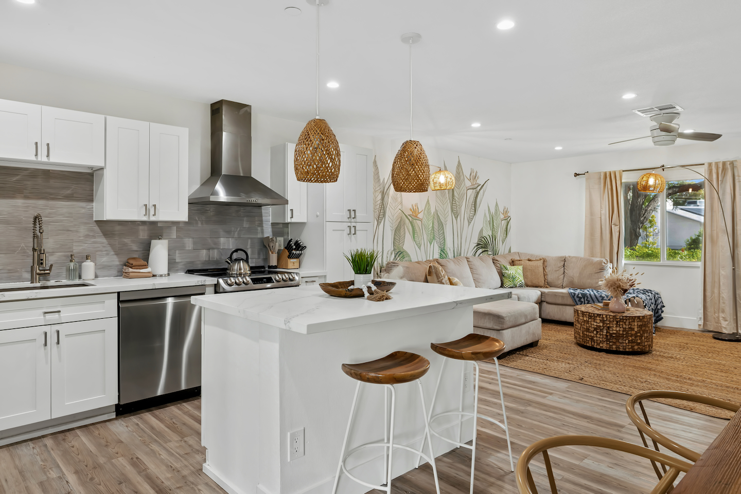 Bright open living with designer kitchen, island seating & cozy lounge