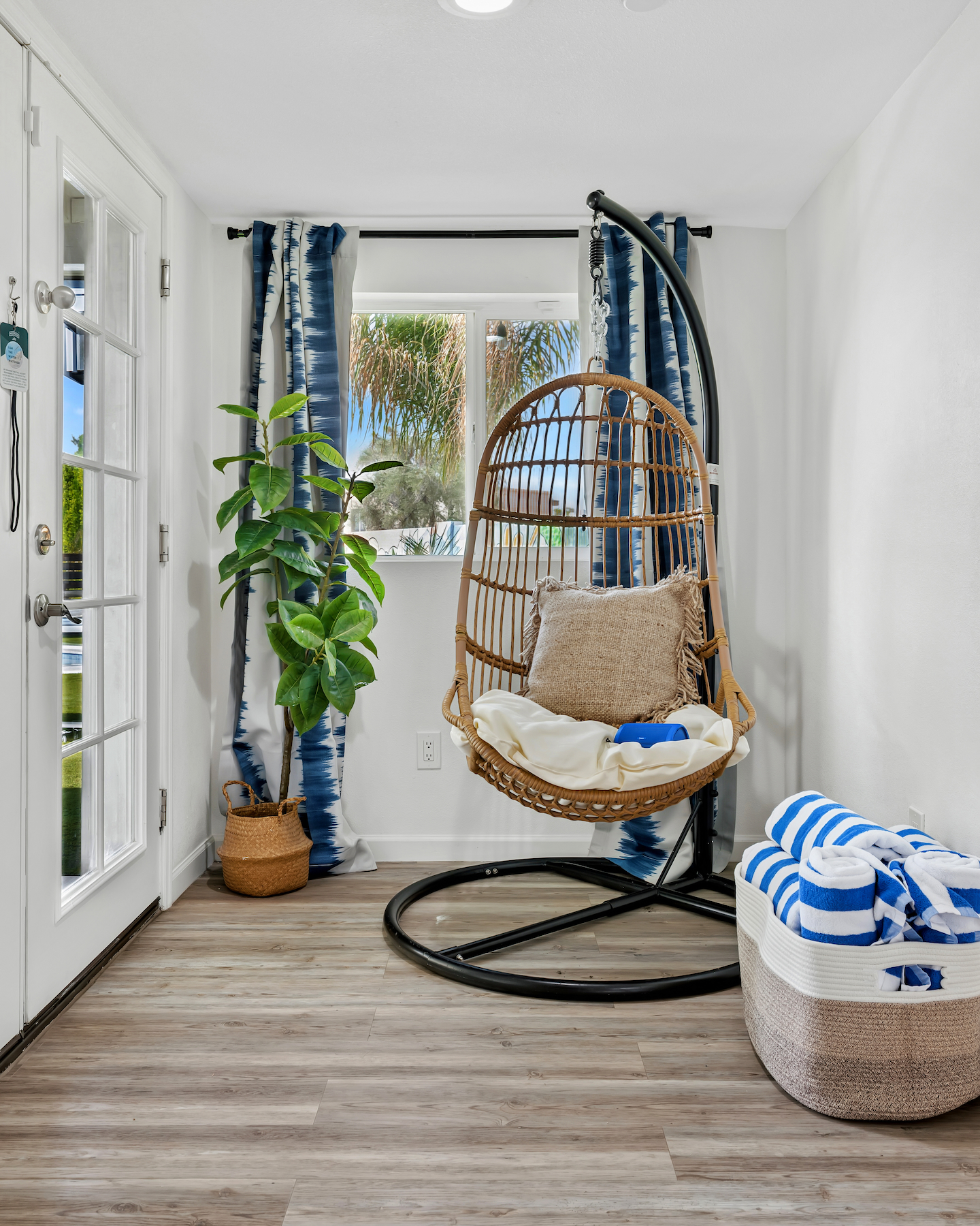 Cozy coastal nook with hanging chair and bright natural light