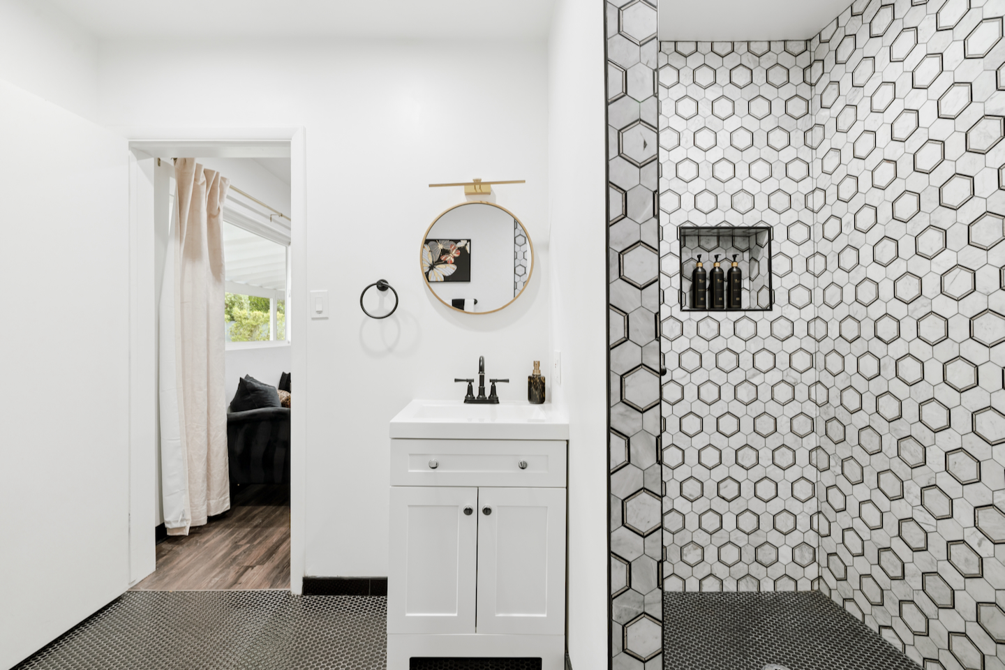Bathroom with single vanity and hex tile walk-in shower