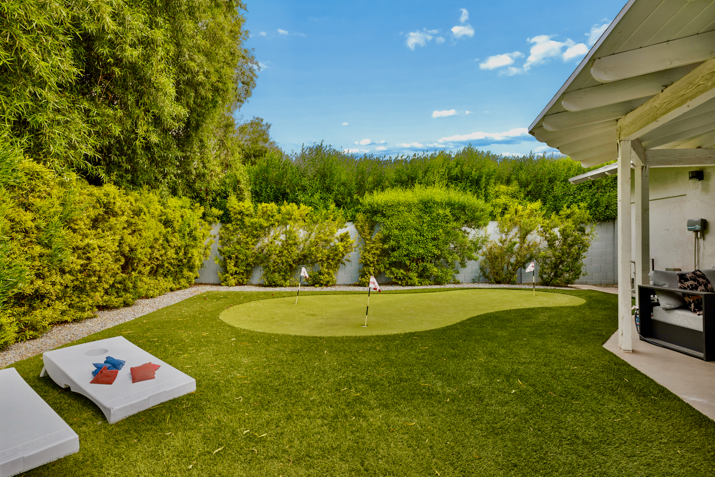 Backyard putting green and turf lawn in the fully fenced yard