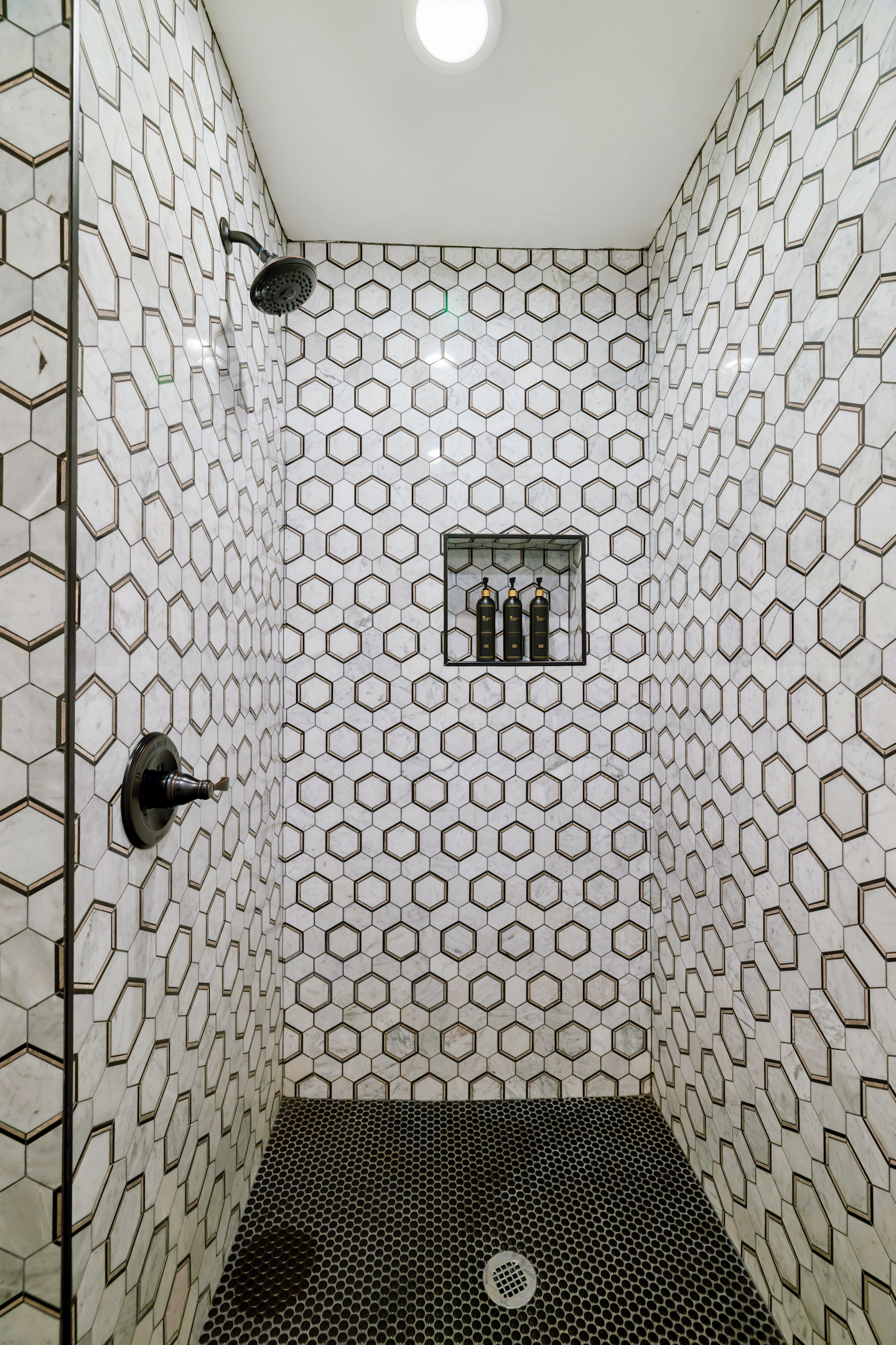 Hex tile walk-in shower with built-in niche